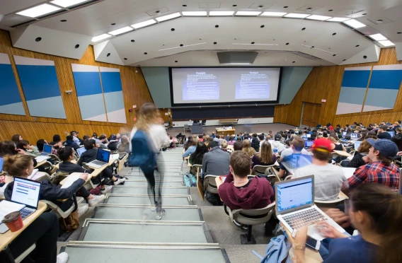 Large university lecture hall filled with students during a classroom presentation.