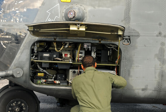 Engineer performs military elicopter maintenance stock