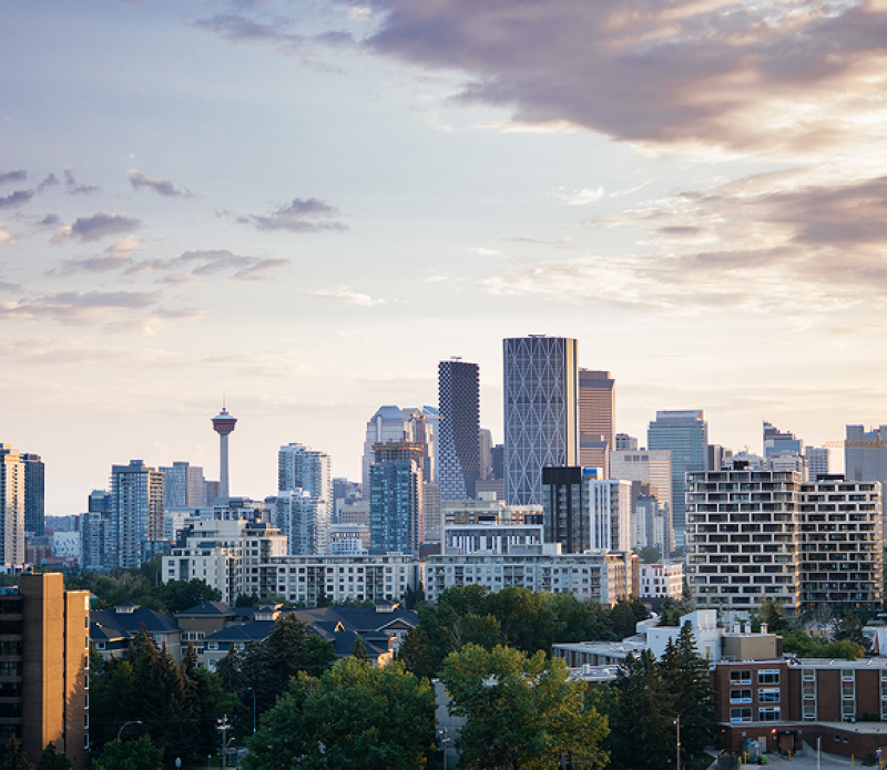 Daytime view of Calgary’s skyline featuring the Calgary Tower, The Bow building, and modern high-rises.